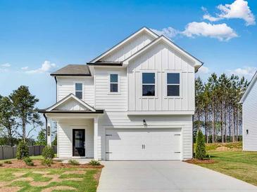 Charming two-story home featuring a white exterior, a two-car garage and a well manicured lawn at 204 Groveton Ct, Euharlee, GA 30145