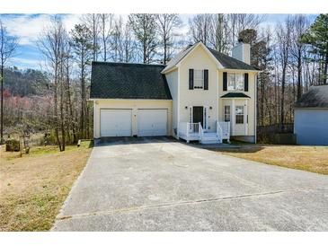 Charming two-story home featuring a two-car garage and welcoming front porch at 581 Victorian Cir, Dallas, GA 30157