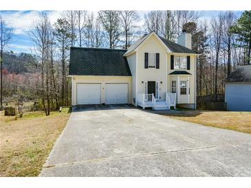 Charming two-story home with a two-car garage and a well-maintained front yard at 581 Victorian Cir, Dallas, GA 30157