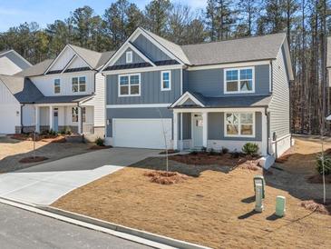 Charming two-story home showcasing a well-manicured front yard and a classic architectural design at 72 Hampton Ter, Dallas, GA 30157