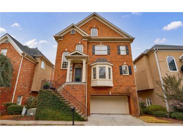 Charming brick home with a two-car garage and landscaped front yard at 1074 Fairway Ne Ests, Atlanta, GA 30319