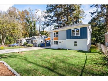 Charming two-story home featuring a lush green lawn, inviting curb appeal and modern exterior paint at 1270 Graymont Sw Dr, Atlanta, GA 30310