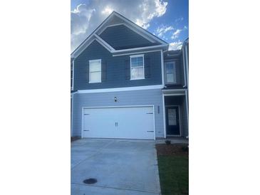 Charming home featuring a two-car garage and well-maintained landscaping at 1029 Northfield Dr, Conyers, GA 30013