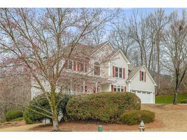 Charming two-story home with white siding, red shutters, and attached two-car garage at 2358 Alexander Farms Sw Ct, Marietta, GA 30064