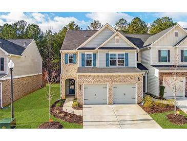 Charming two-story home with a brick facade, two-car garage and blue shutters at 5620 Berney Cir, Powder Springs, GA 30127