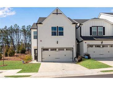 Modern two-story home with a white brick exterior and a spacious two-car garage at 1733 Hyssop Blvd, Mableton, GA 30126