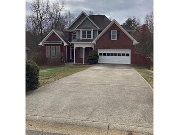 Charming brick home with a two-car garage and long driveway at 1630 Stonehaven, Cumming, GA 30040