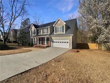 Charming two-story home with a two-car garage and a long driveway, set on a well-maintained lot at 1997 Alcovy Trace Way, Lawrenceville, GA 30045