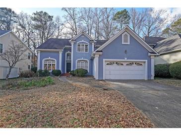 Charming blue two-story home with attached two-car garage and well-maintained landscaping at 2910 Mitchell Ne Cv, Brookhaven, GA 30319