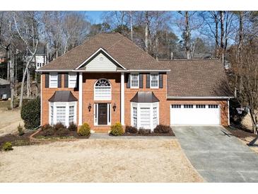 Charming two-story brick home with a well-manicured front yard and attached two car garage at 685 Trailwood Sw Ln, Marietta, GA 30064