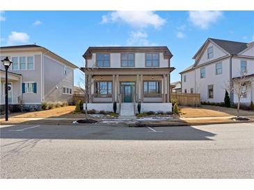 Charming two-story home featuring a welcoming front porch with classic architectural details at 1360 Flora Dr, Conyers, GA 30094