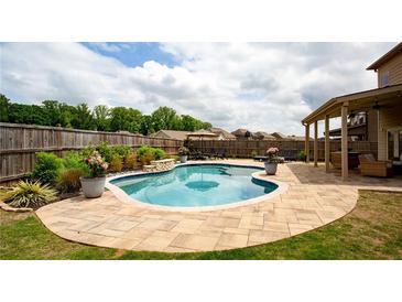 Inviting backyard pool and patio area, perfect for relaxing or entertaining at 5160 Meridian Pass, Cumming, GA 30028