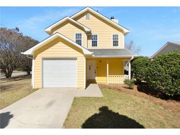 Charming yellow two-story home with attached garage and inviting front porch at 1090 Ohara Dr, Jonesboro, GA 30236