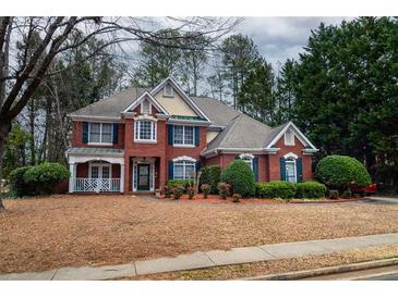 Charming two-story brick home featuring manicured landscaping and a welcoming front porch at 1159 Bowerie Chase, Powder Springs, GA 30127