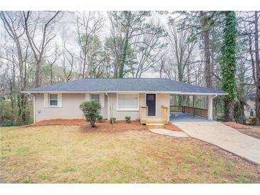 Charming single-story home with a covered carport and a well-maintained front yard at 3651 Tulip Dr, Decatur, GA 30032