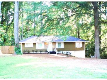 Charming single-story home with a well-maintained lawn and mature trees providing shade and privacy at 2959 Meadowview Se Dr, Atlanta, GA 30316