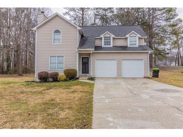 Charming two-story home with attached two-car garage and a well-maintained front lawn at 116 Black Oak Ct, Stockbridge, GA 30281