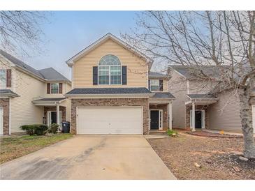Charming two-story home featuring a brick facade, attached garage, and well-maintained landscaping at 11143 Aliyah Dr, Hampton, GA 30228