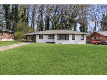 Single story house featuring a well manicured lawn, carport and a freshly painted exterior at 1808 Brewer Sw Blvd, Atlanta, GA 30310