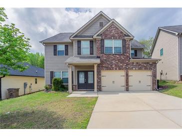 Charming two-story home with a brick facade and a two-car garage at 4950 Summersun Dr, Morrow, GA 30260