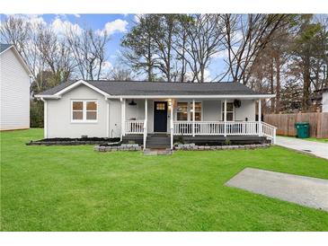 Charming single-story home with a well-manicured lawn and inviting front porch at 541 Benmac Se Rd, Smyrna, GA 30080