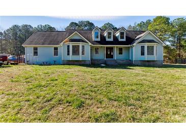 Charming home featuring a well-manicured lawn and traditional architectural details at 1505 Ozora Rd, Loganville, GA 30052