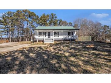 Charming one story home featuring a well-maintained lawn and inviting front porch at 60 Collins Rd, Carrollton, GA 30116