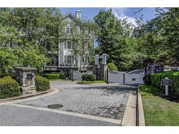 Elegant gated entrance to a private property surrounded by lush landscaping at 4100 Paces Se Walk # 3205, Atlanta, GA 30339