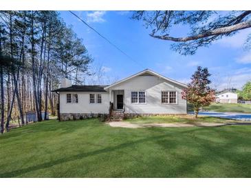 Charming single-story home with a well-manicured lawn and classic white siding at 374 Lamancha Ct, Lawrenceville, GA 30044