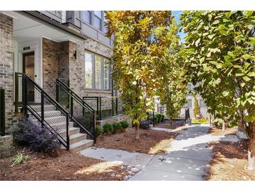 Beautiful brick townhome featuring a well-manicured yard and inviting entrance staircase at 383 Pratt Se Dr # 503, Atlanta, GA 30315