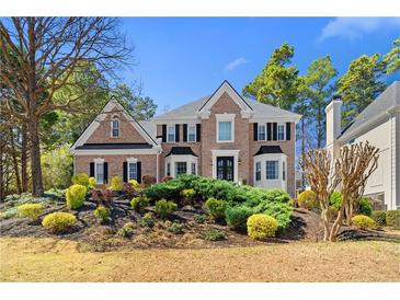 Beautiful two story brick home with mature landscaping and a manicured lawn at 65 Gatewood Dr, Marietta, GA 30068