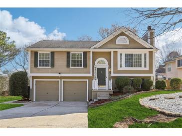 Charming two-story home featuring a well-maintained lawn, two-car garage, and cozy front porch with 'Welcome' sign at 10475 Willow Meadow Cir, Alpharetta, GA 30022
