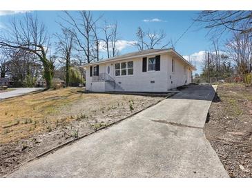 Charming home with a white painted brick exterior and long driveway in a quiet neighborhood at 1189 Kathryn Cir, Forest Park, GA 30297