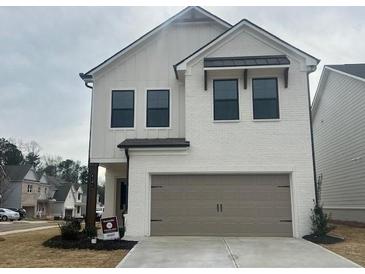 Charming new construction featuring a brick and clapboard facade, and a two-car garage at 4371 Portsbrook Ave, Snellville, GA 30039