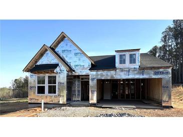 A home under construction with visible framing and weatherproofing, showing potential for customization at 156 Easton Park Blvd, Dallas, GA 30157