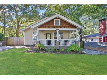 Charming bungalow-style home with a welcoming front porch and a well-manicured lawn at 265 Haas Se Ave, Atlanta, GA 30316