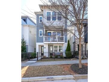 Charming three-story home featuring a balcony, white trim, and a well-maintained yard at 419 Hargrove Ln, Decatur, GA 30030