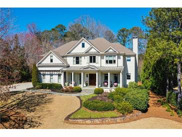 Stately home featuring a manicured front lawn and a charming front porch with classic white columns at 3150 Shumard Way, Marietta, GA 30064
