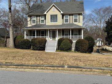 Charming two-story home featuring a welcoming front porch and well-maintained landscaping at 722 Thornapple Trl, Lawrenceville, GA 30046