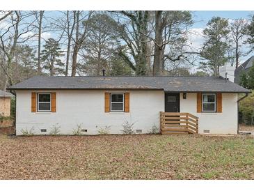 Charming renovated brick home with black trim, wooden shutters, and a new roof at 1700 Shirley Sw St, Atlanta, GA 30310