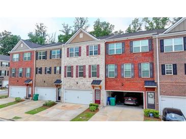 Charming multi-level townhomes showcasing diverse brick and siding exteriors with private garages at 2137 Post Grove Rd, Snellville, GA 30078