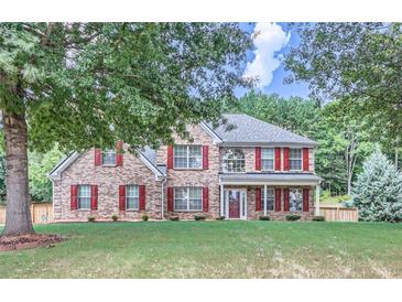 Charming two-story brick home featuring red shutters and a well-maintained front yard at 117 Kiara Ln, Stockbridge, GA 30281