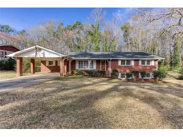 Charming brick home with a covered carport and well-maintained front yard at 6582 Malvin Dr, Mableton, GA 30168