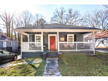 Charming single-story home with a welcoming front porch and red front door, perfect for relaxing outdoors at 444 W Lake Nw Ave, Atlanta, GA 30318