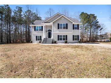 Charming two-story home with a manicured lawn, covered front porch, and a classic design at 225 Stonewood Ct, Temple, GA 30179