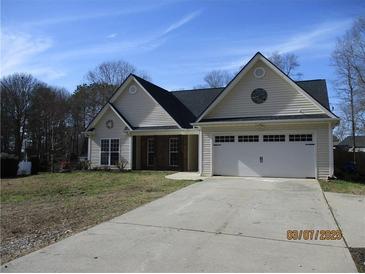 Charming single-story home features a two-car garage, well-manicured lawn, and inviting curb appeal at 561 Old Loganville Rd, Loganville, GA 30052