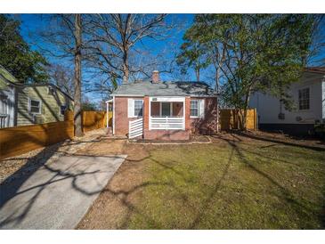 Charming brick home with a well-maintained front yard and classic architectural details at 1475 Elizabeth Ln, Atlanta, GA 30344