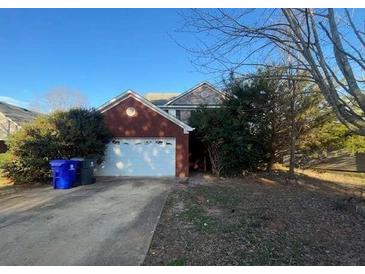 Charming two-story brick home with a well-maintained front yard and attached two-car garage at 304 Klinetop Dr, Mcdonough, GA 30253