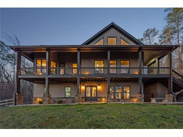 Stunning two-story home with a covered porch, stone accents, and professional landscaping at 101 Bevil Ridge Se Rd, Emerson, GA 30137