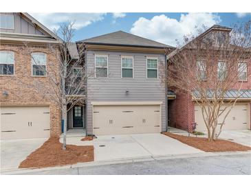 Charming two-story home featuring a spacious two-car garage, complemented by a landscaped front yard at 2275 W Village Se Ln, Smyrna, GA 30080